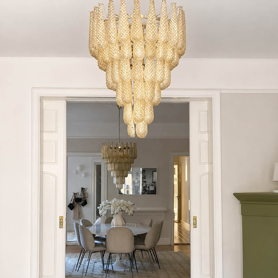 Stella Murano glass teardrop chandelier polished gold frame living room art deco Hollywood Regency Italian luxury warm glow lifestyle interior