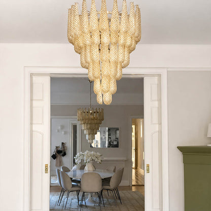 Stella Murano glass teardrop chandelier polished gold frame living room art deco Hollywood Regency Italian luxury warm glow lifestyle interior