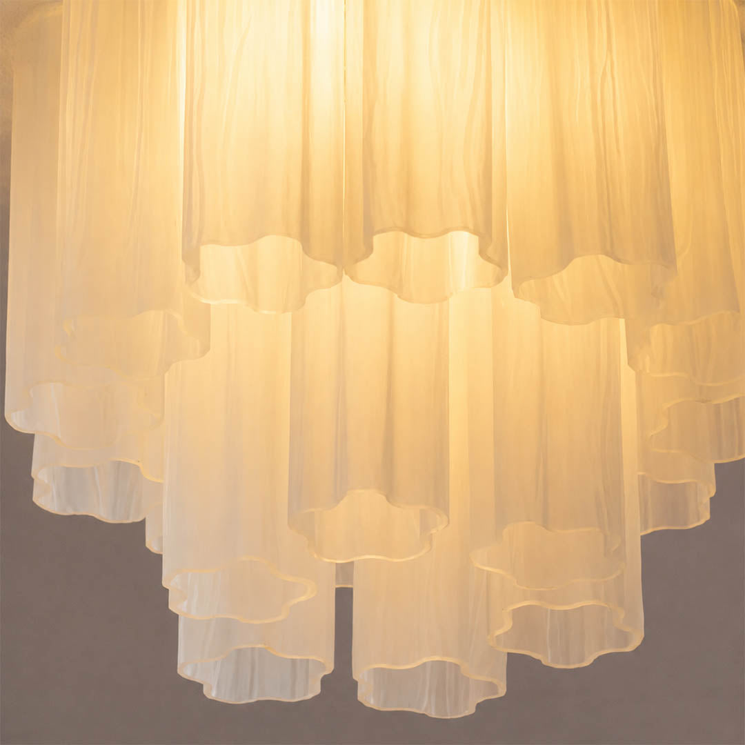 Close-up of one star-shaped glass tube, showing ridges, glass thickness, reflections, and subtle handcrafted variation. Clean neutral background.