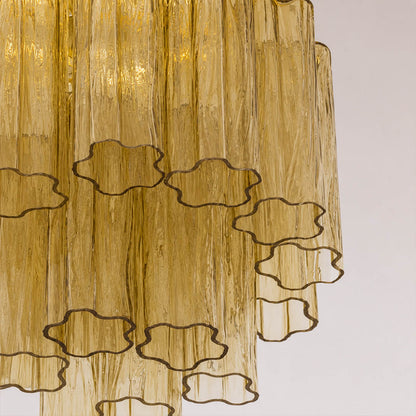 Close-up of one star-shaped glass tube, showing ridges, glass thickness, reflections, and subtle handcrafted variation. Clean neutral background.