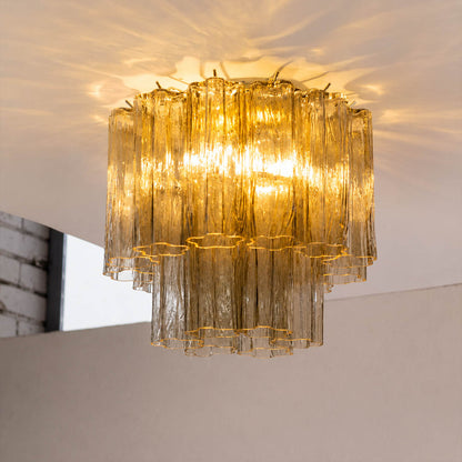 Close-up of warm light passing through the textured glass tubes. Keep the original glass color visible and avoid overexposure.