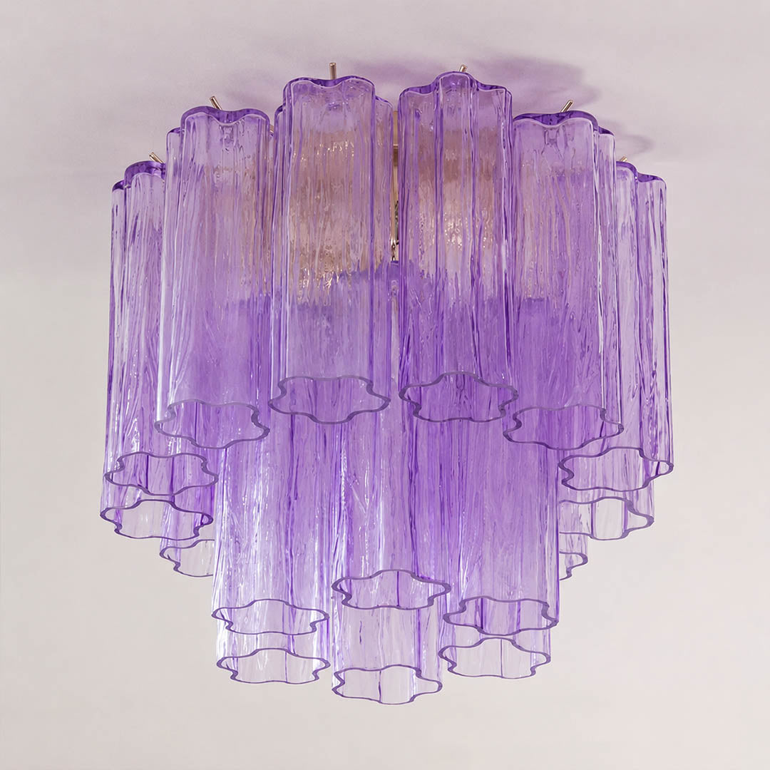 Pure white background, exact Stellina ceiling light with translucent smoky-purple glass and polished gold frame. Light off, centered three-quarter view, no neon color or plastic texture.
