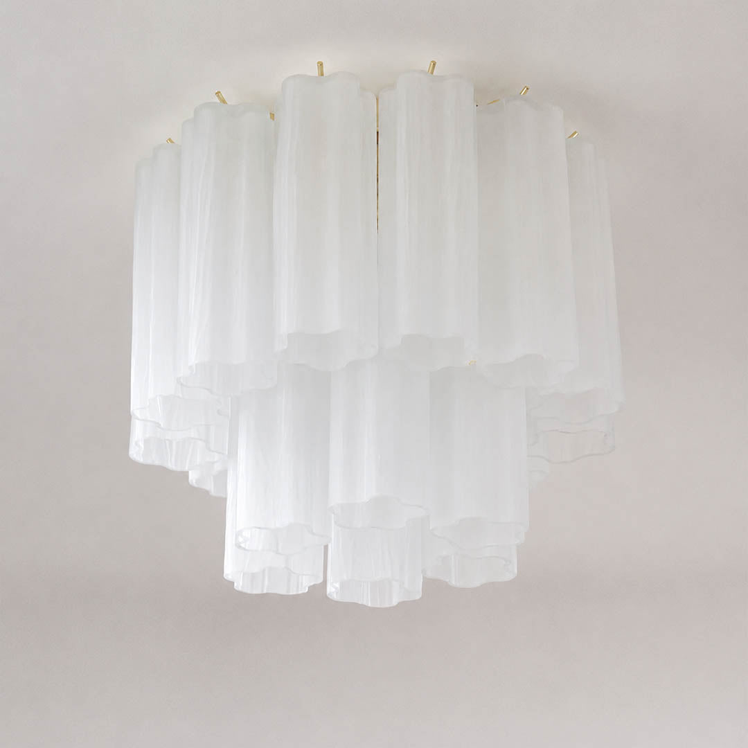 Pure white background, exact Stellina ceiling light with translucent white star-shaped glass tubes and polished gold frame. Light off, centered three-quarter view, realistic glass reflections, no props or text.