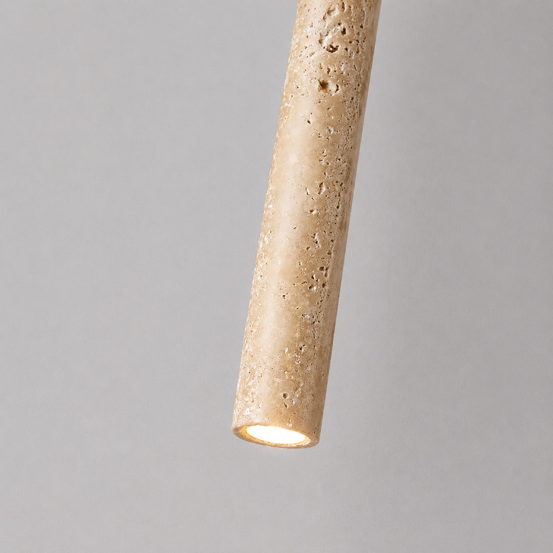 Stelo travertine pendant light illuminated warm light glowing stone veining amber detail