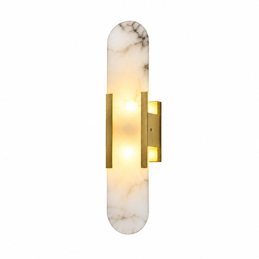 Stilo alabaster wall sconce with a slim cylindrical natural stone shade glowing warm on a wall