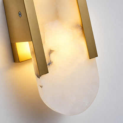 Detail of the brass caps on the top and bottom of the Stilo alabaster wall sconce