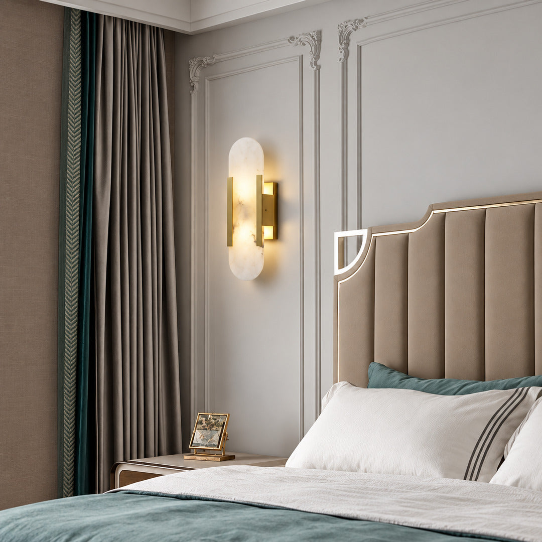 Pair of Stilo alabaster wall sconces flanking a bed for warm symmetrical bedside lighting