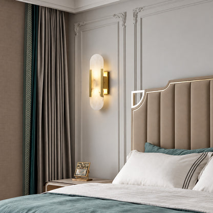 Pair of Stilo alabaster wall sconces flanking a bed for warm symmetrical bedside lighting