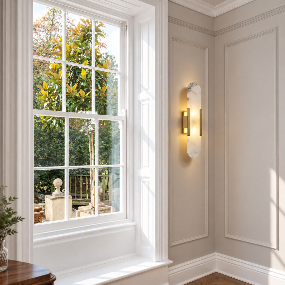 Stilo alabaster wall sconce as a slim warm accent on a modern living room wall