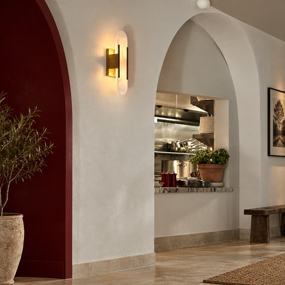 Row of Stilo alabaster wall sconces lining a luxury hotel corridor with a warm glow