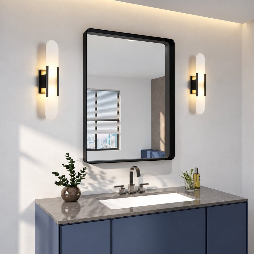 Pair of Stilo alabaster wall sconces flanking a vanity mirror in a dry powder room
