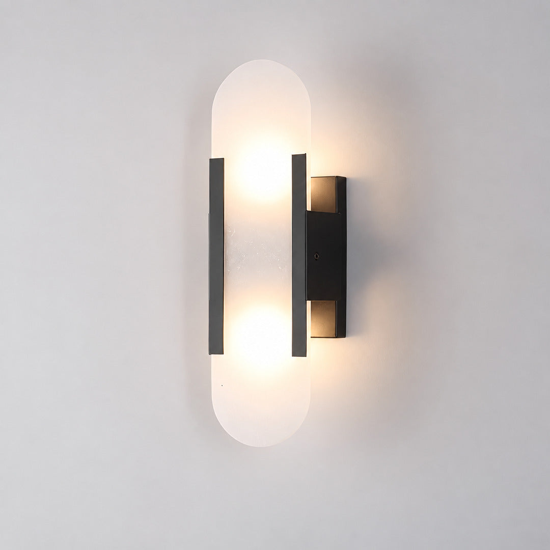 Short 13.8-inch black Stilo alabaster wall sconce on a modern hallway wall
