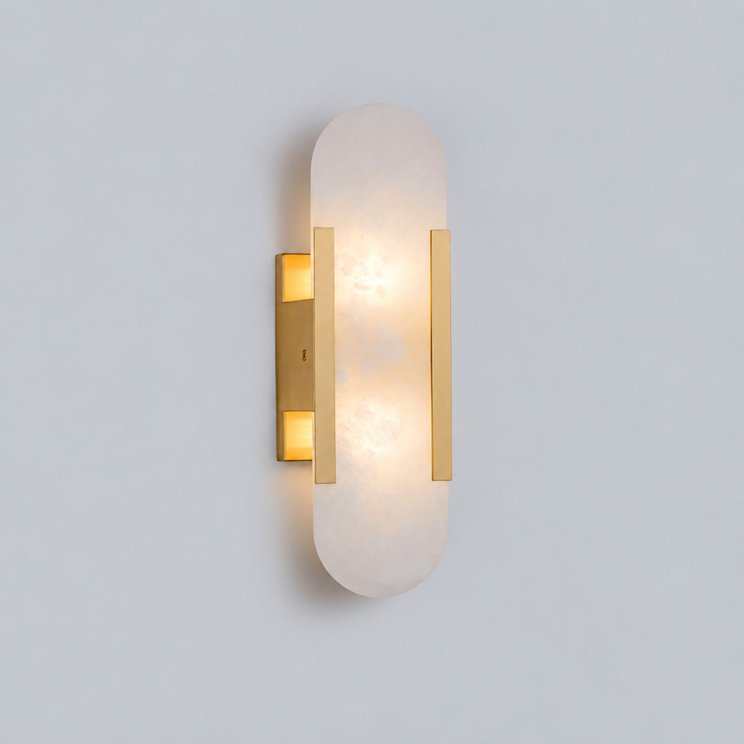 Short 13.8-inch brass Stilo alabaster wall sconce as a slim accent beside a bed
