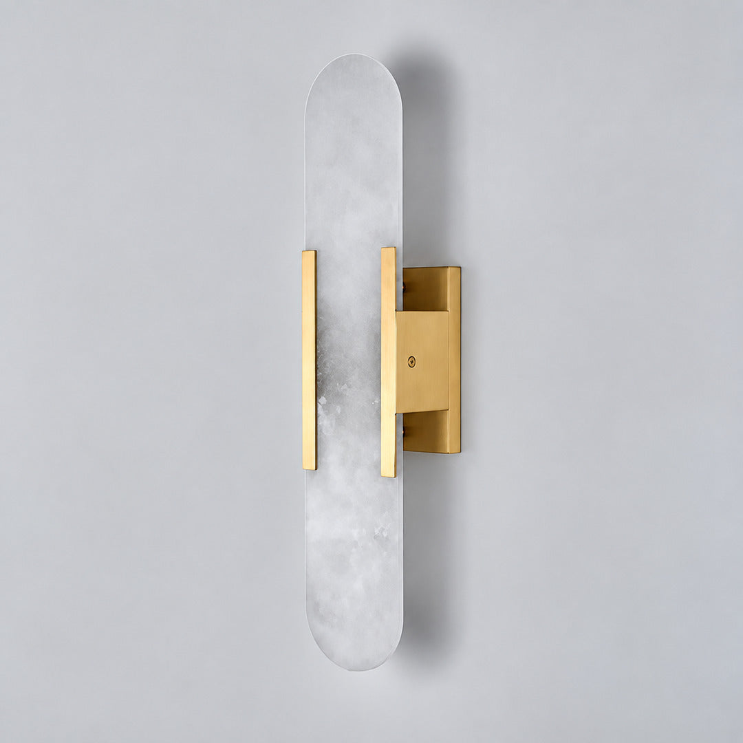 Close-up of the slim cylindrical alabaster shade on the Stilo wall sconce lit from within