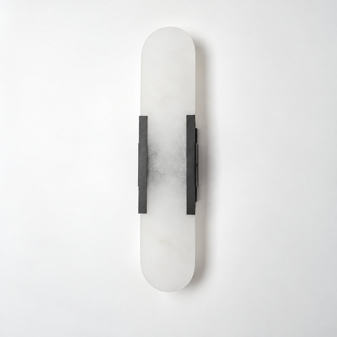 Close-up of the slim cylindrical alabaster shade on the Stilo wall sconce lit from within