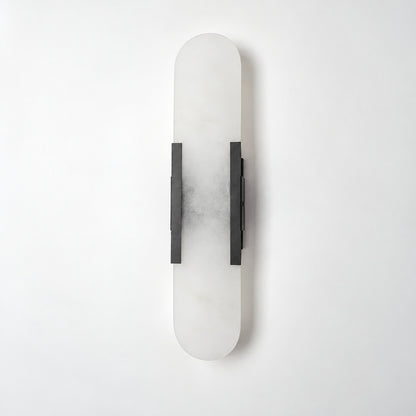 Close-up of the slim cylindrical alabaster shade on the Stilo wall sconce lit from within