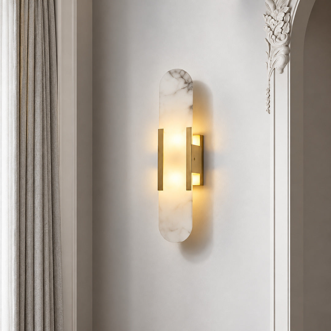 Stilo alabaster wall sconce welcoming guests with a warm vertical glow above an entry console