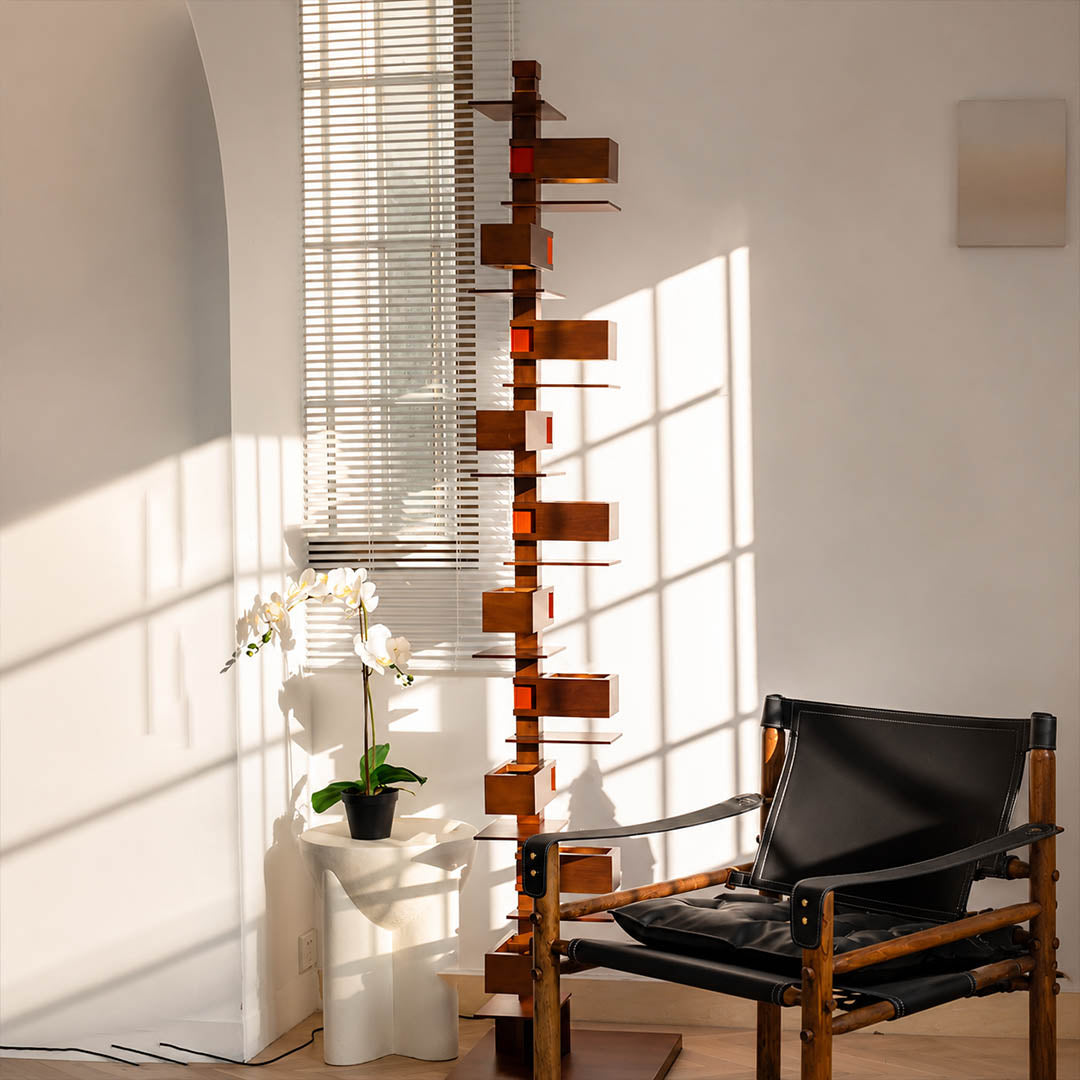 Strato floor lamp black modern living room reading armchair corner statement art deco layered Prairie School inspired warm ambient glow architectural intimate sophisticated lifestyle interior American home