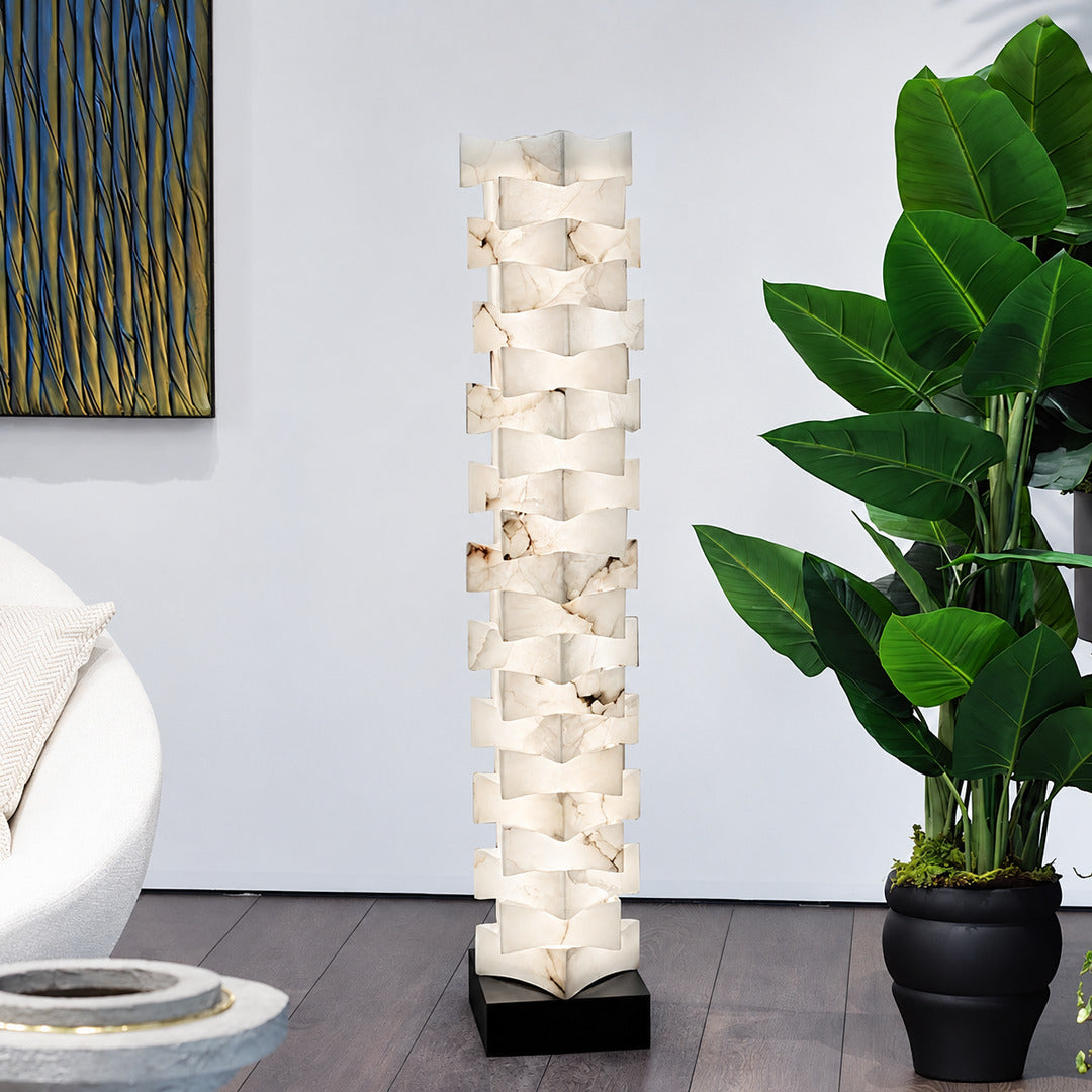 Strato alabaster floor lamp beside an armchair in a bedroom reading corner
