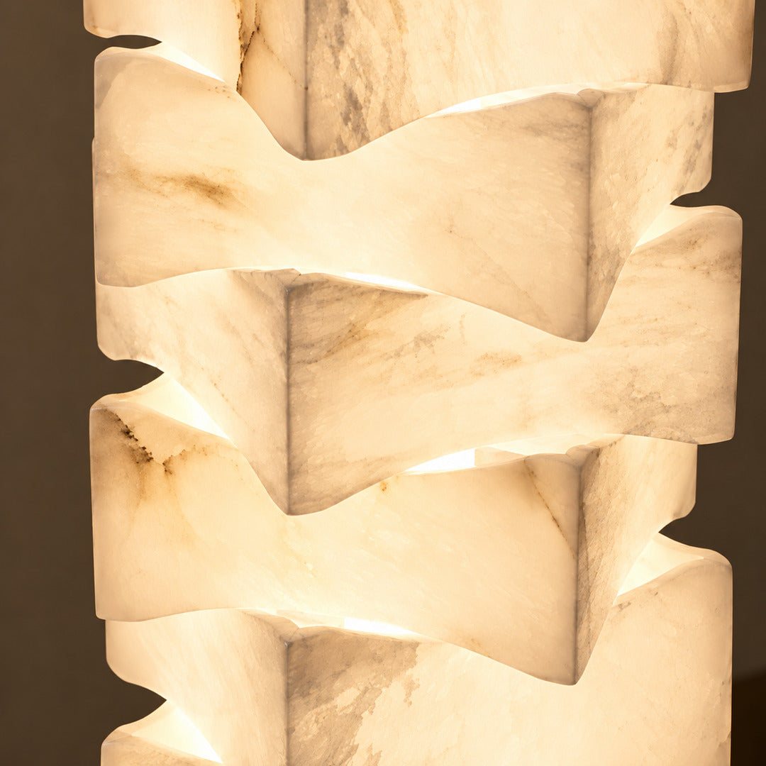 Close-up of natural veining glowing through the stacked alabaster blocks of the Strato floor lamp
