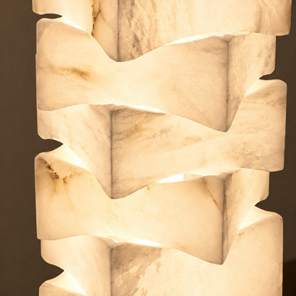 Close-up of natural veining glowing through the stacked alabaster blocks of the Strato floor lamp
