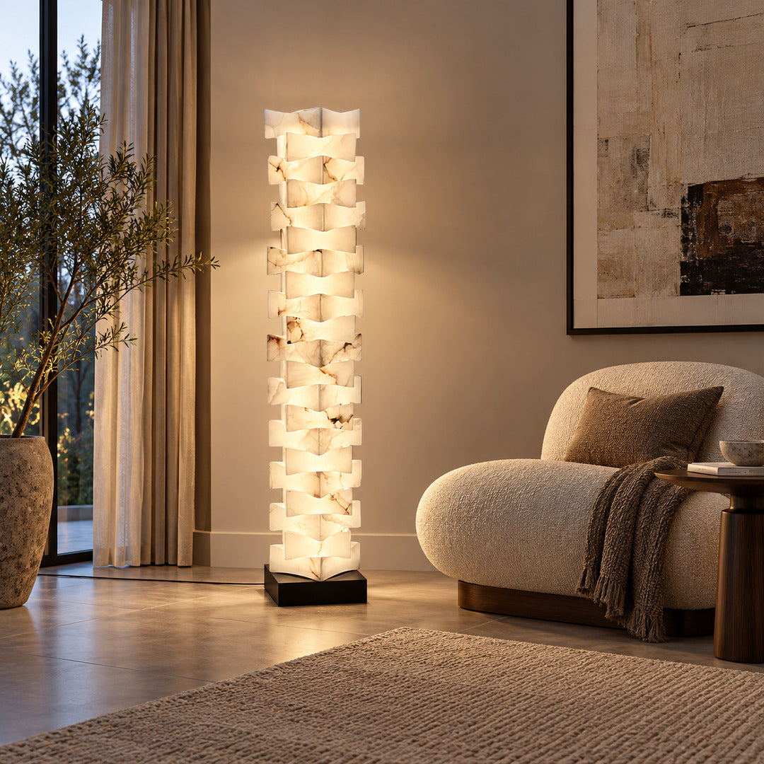 Strato alabaster floor lamp beside an armchair in a bedroom reading corner
