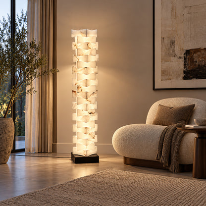 Strato alabaster floor lamp beside an armchair in a bedroom reading corner