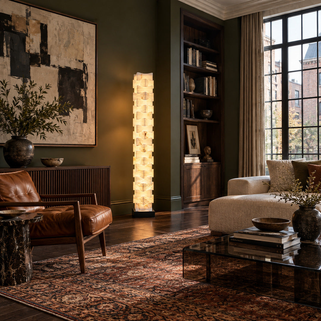 Strato stacked alabaster floor lamp beside a sofa in a modern living room