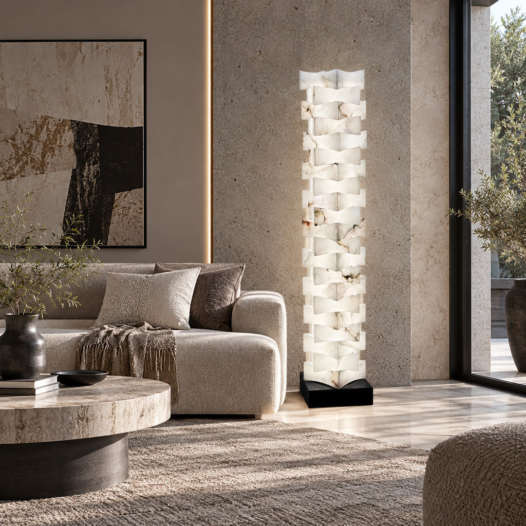 Strato stacked alabaster floor lamp beside a sofa in a modern living room