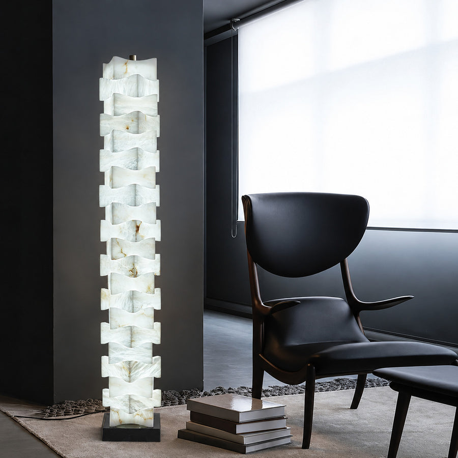 Strato alabaster floor lamp beside an armchair in a bedroom reading corner