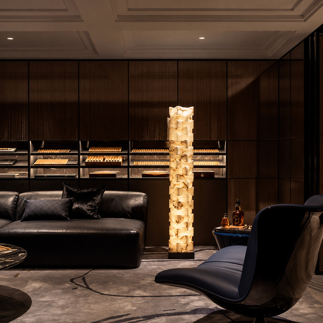 Strato stacked alabaster floor lamp beside a sofa in a modern living room