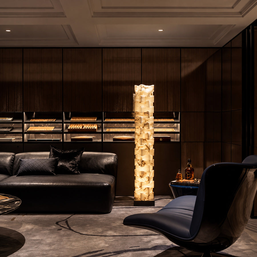 Strato stacked alabaster floor lamp beside a sofa in a modern living room