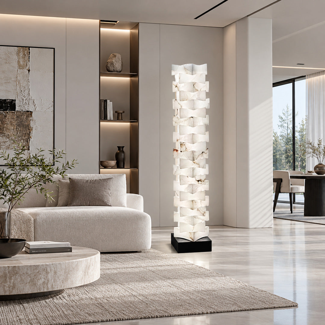 Strato stacked alabaster floor lamp beside a sofa in a modern living room