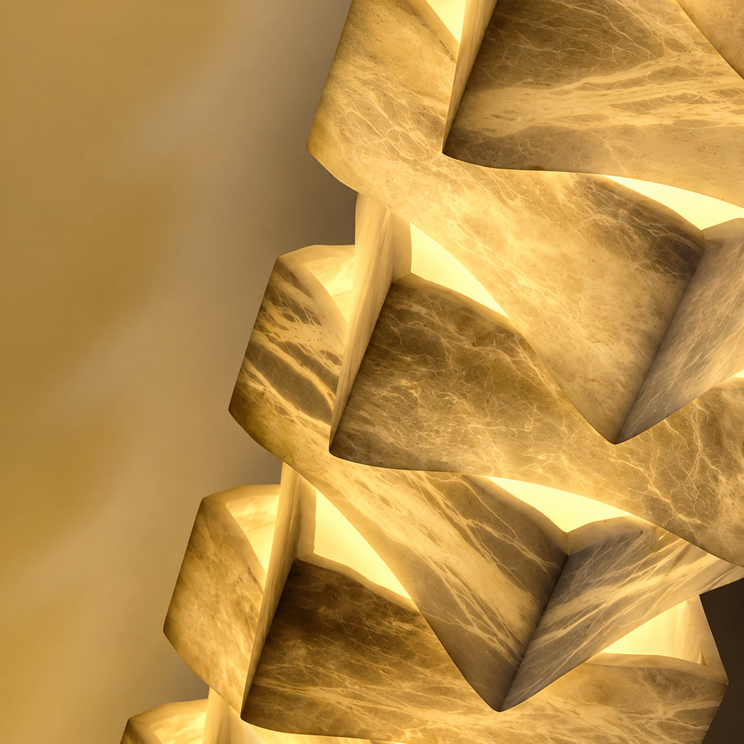 Close-up of natural veining glowing through the stacked alabaster blocks of the Strato floor lamp