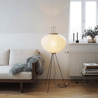Stuber premium handcrafted off-white washi paper tripod floor lamp with black legs illuminating a modern Japandi living room.