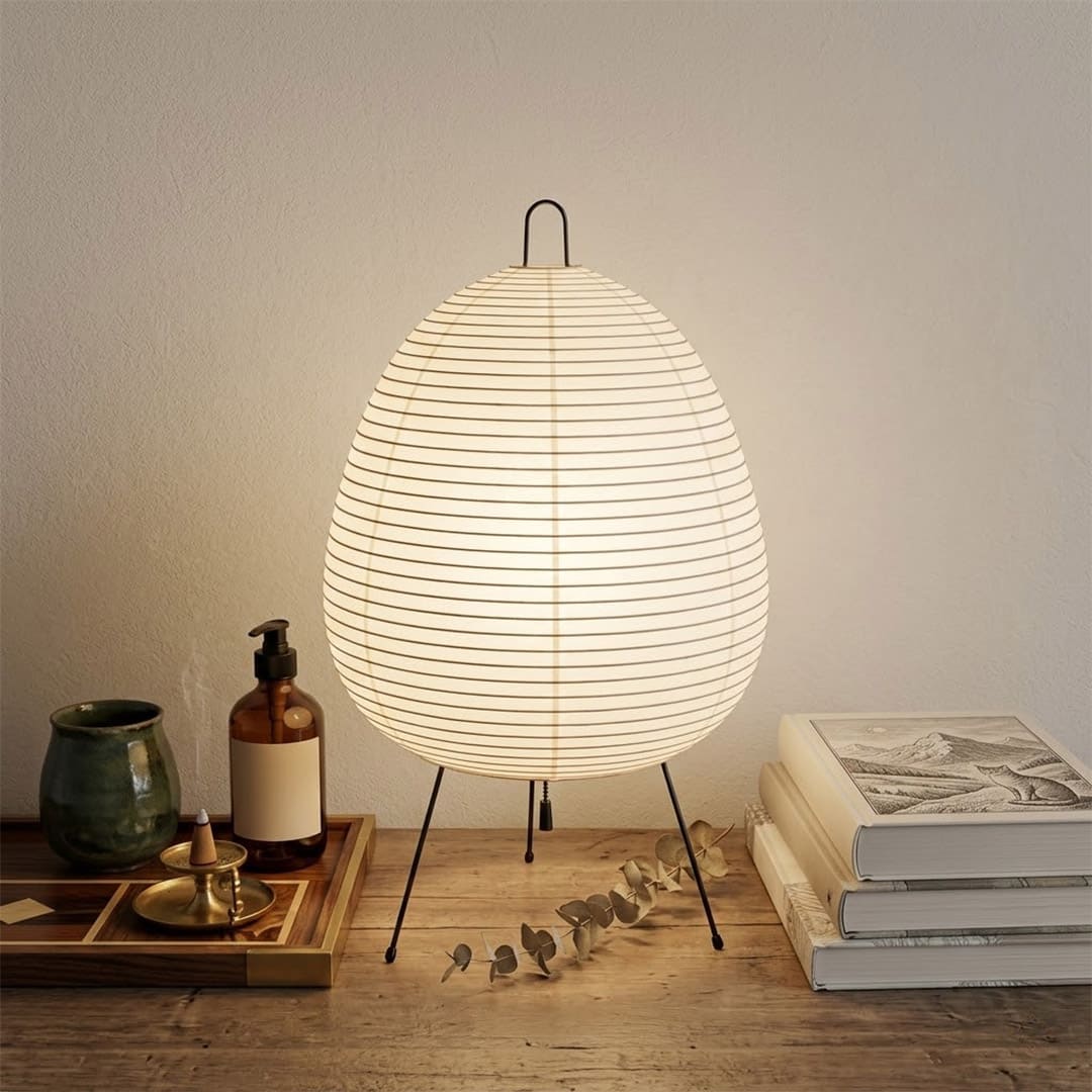 Stuberlighting classic egg-shaped Washi paper table lamp on black tripod legs.