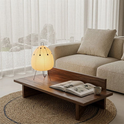 Stuberlighting classic egg-shaped Washi paper table lamp on black tripod legs.