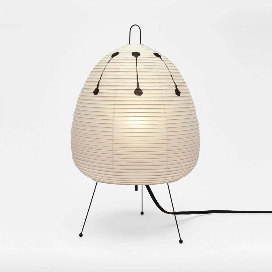 Stuber classic egg-shaped Washi paper table lamp on black tripod legs.