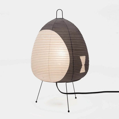 Stuber classic egg-shaped Washi paper table lamp on black tripod legs.