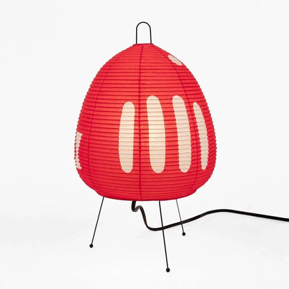 Stuber classic egg-shaped Washi paper table lamp on black tripod legs.
