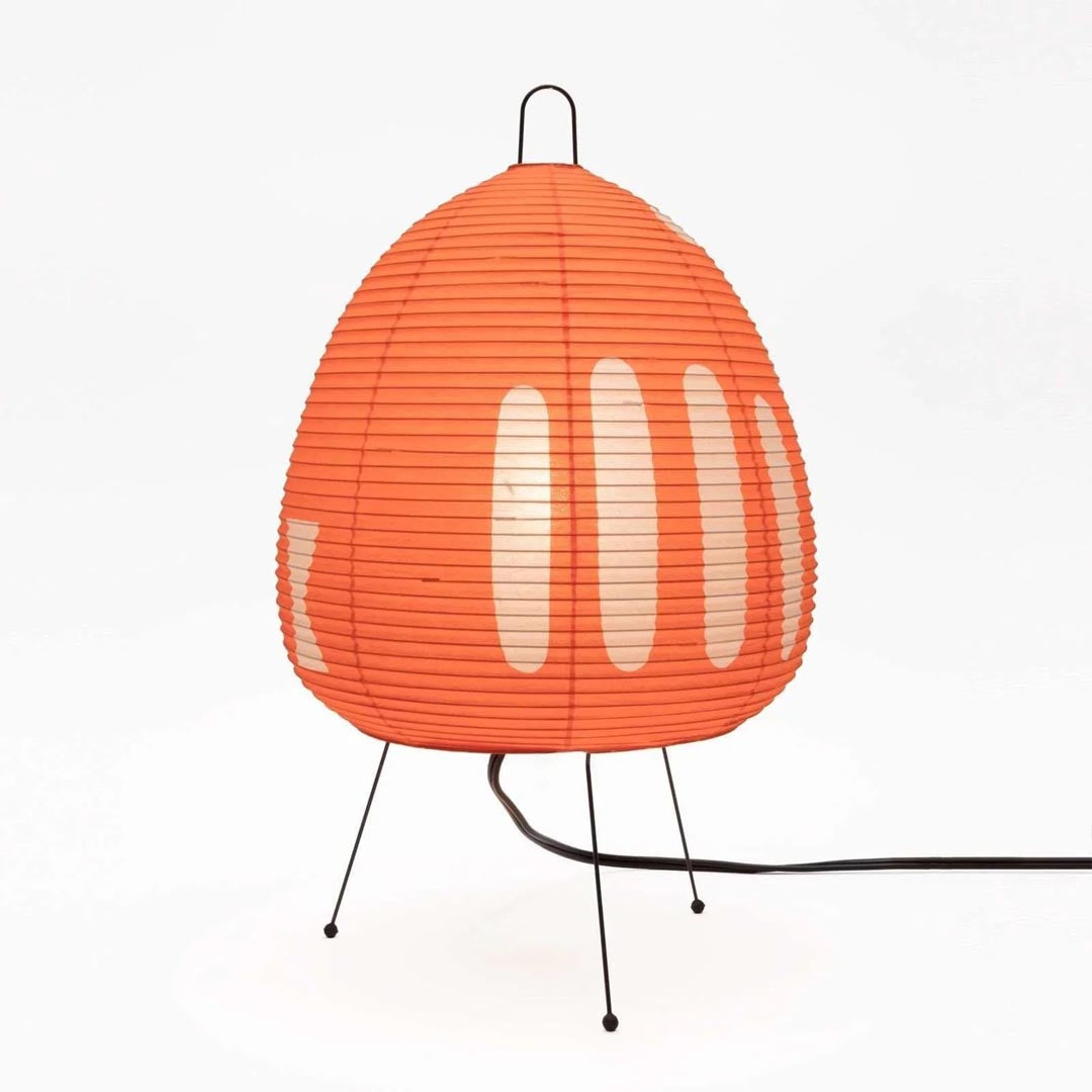 Stuberlighting classic egg-shaped Washi paper table lamp on black tripod legs.