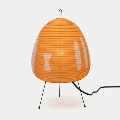 Stuber classic egg-shaped Washi paper table lamp on black tripod legs.