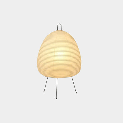 Stuber classic egg-shaped Washi paper table lamp on black tripod legs.