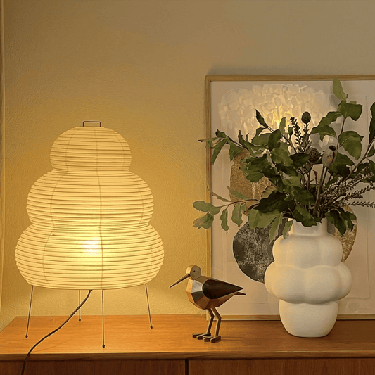 Stuberlighting 25N large Washi paper floor lamp with three-tiered silhouette in a warm minimalist living room setting.