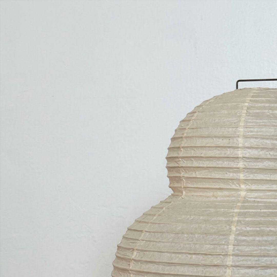 Stuberlighting 25N large Washi paper floor lamp with three-tiered silhouette in a warm minimalist living room setting.