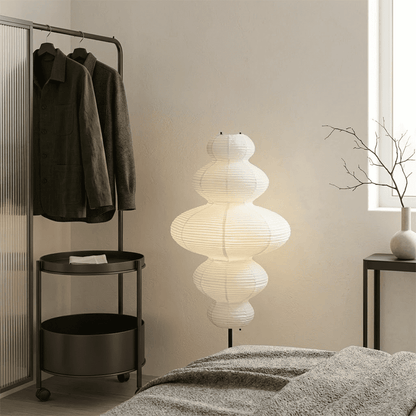Handcrafted Chigiri Washi paper tower floor lamp with hand-torn mulberry paper texture and matte black base.