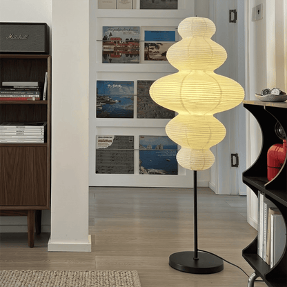 Handcrafted Chigiri Washi paper tower floor lamp with hand-torn mulberry paper texture and matte black base.