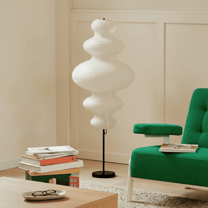 Handcrafted Chigiri Washi paper tower floor lamp with hand-torn mulberry paper texture and matte black base.