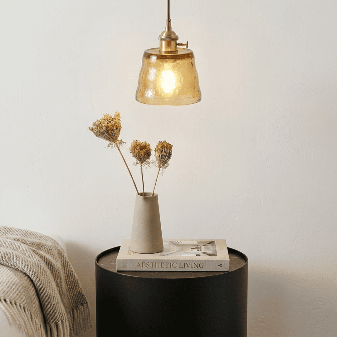 Nordic Cup amber pendant light above bedside table dried flowers bedroom