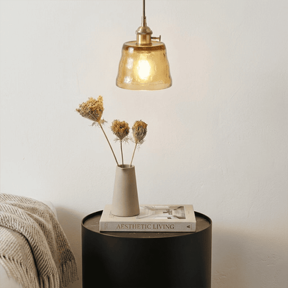 Nordic Cup amber pendant light above bedside table dried flowers bedroom